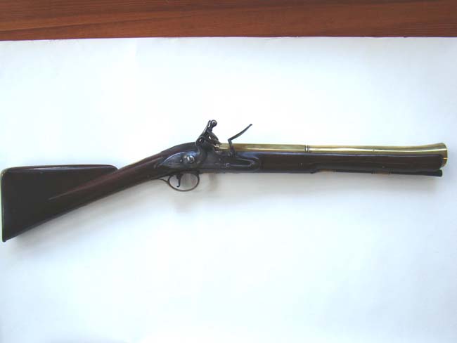 A RARE Revolutionary War period brass barreled blunderbuss by John Steele of London circa 1770 - 1780 inscribed "HAPPY IS HE WHO ESCAPETH ME"
